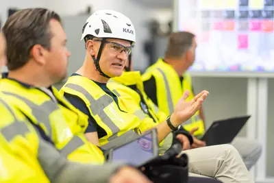 Site team in a project briefing, a member making a point