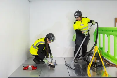 Two workers carrying out the final clean in a finished room