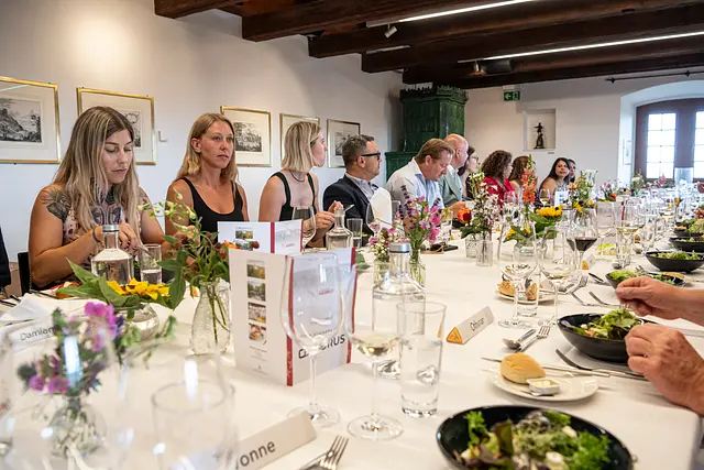 A laid festive table for dinner in the Knights' Hall with floral arrangements.